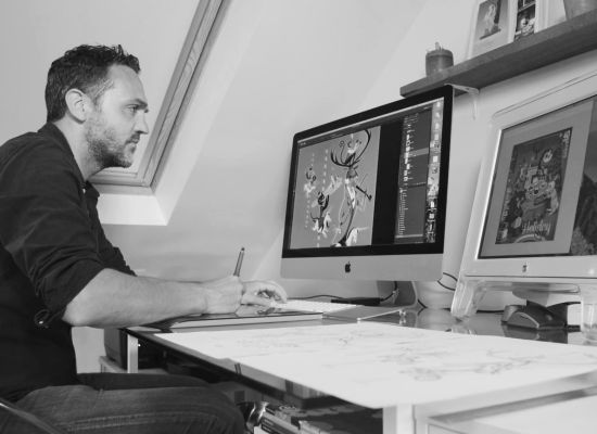 Ben Kirchner freelance illustrator working at a computer